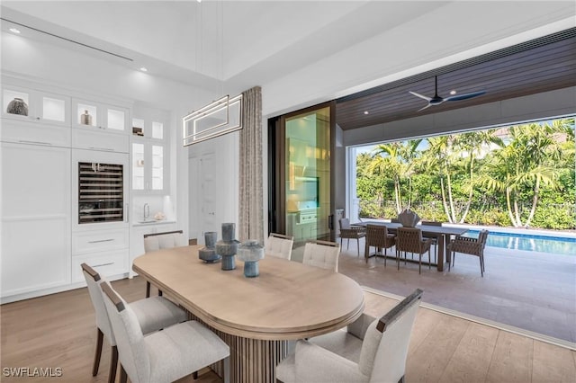 dining area featuring ceiling fan and light wood-type flooring