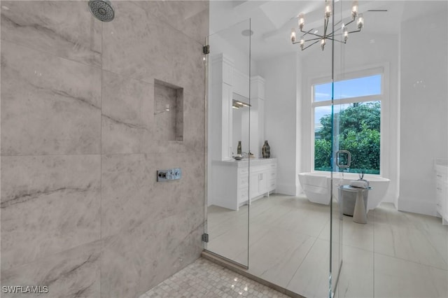 bathroom with tile patterned flooring, vanity, plus walk in shower, and a chandelier