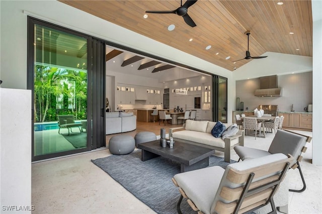 living room featuring ceiling fan, wooden ceiling, and lofted ceiling