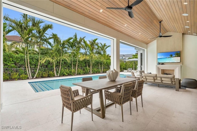 exterior space with a wealth of natural light, ceiling fan, and wood ceiling