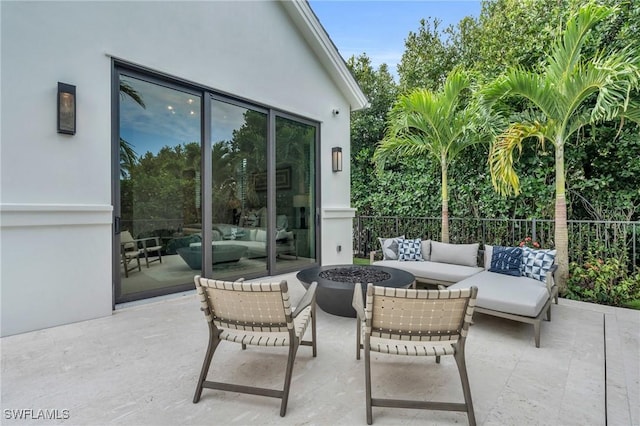 view of patio / terrace featuring an outdoor living space with a fire pit