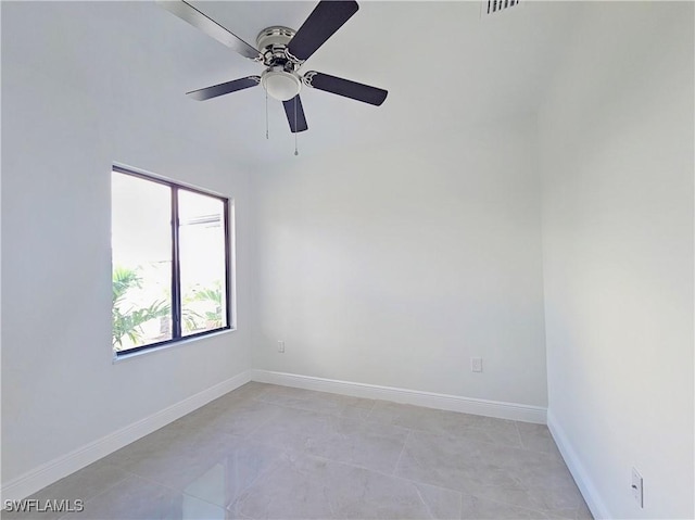 tiled empty room with ceiling fan