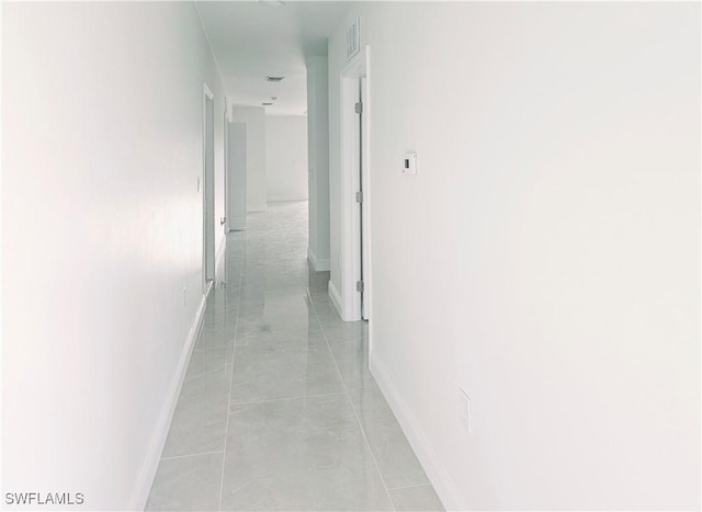 corridor featuring light tile patterned floors