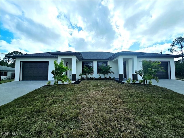 view of front of house with a garage and a front lawn