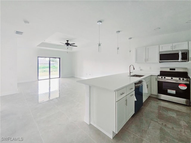 kitchen featuring kitchen peninsula, stainless steel appliances, ceiling fan, sink, and white cabinets