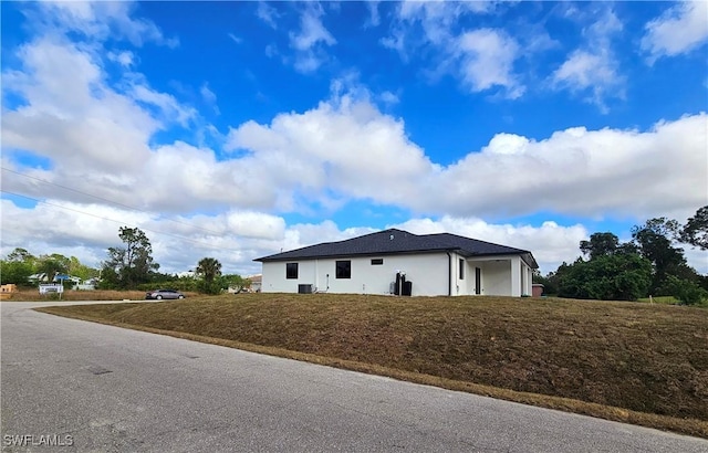 view of property exterior featuring a lawn