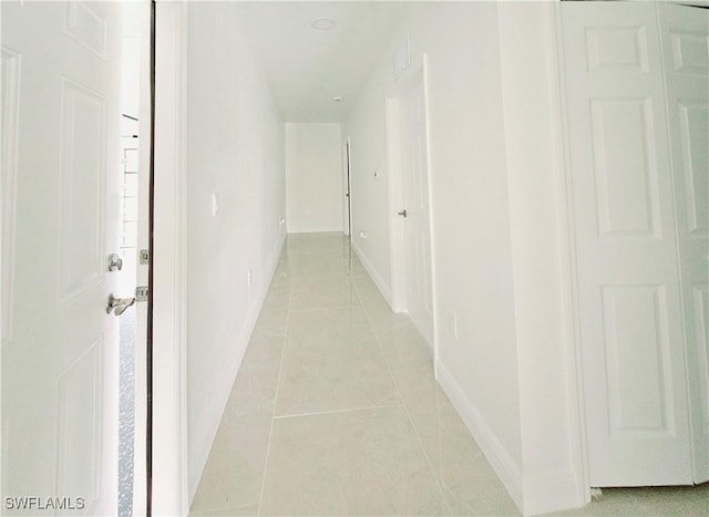 hall featuring light tile patterned floors