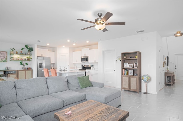 living room with ceiling fan and light tile patterned flooring