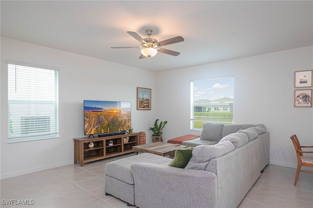 living room with ceiling fan and light tile patterned floors