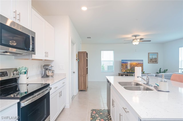 kitchen with white cabinetry, a center island with sink, stainless steel appliances, and sink