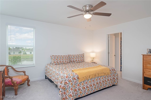 carpeted bedroom with ceiling fan and multiple windows