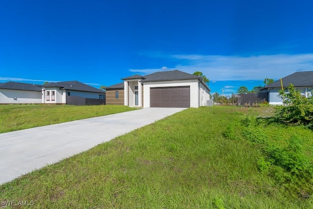 view of front of home with a front yard and a garage