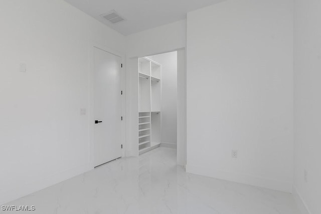 walk in closet featuring marble finish floor and visible vents