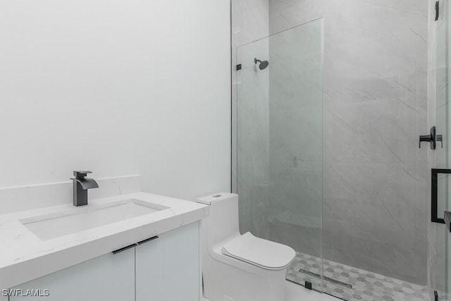 full bathroom with toilet, vanity, and a marble finish shower