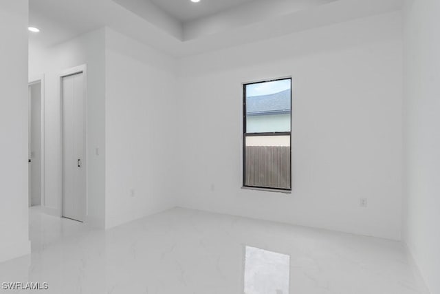 unfurnished room featuring marble finish floor and recessed lighting