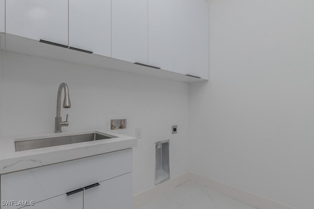 clothes washing area featuring cabinet space, a sink, marble finish floor, washer hookup, and electric dryer hookup