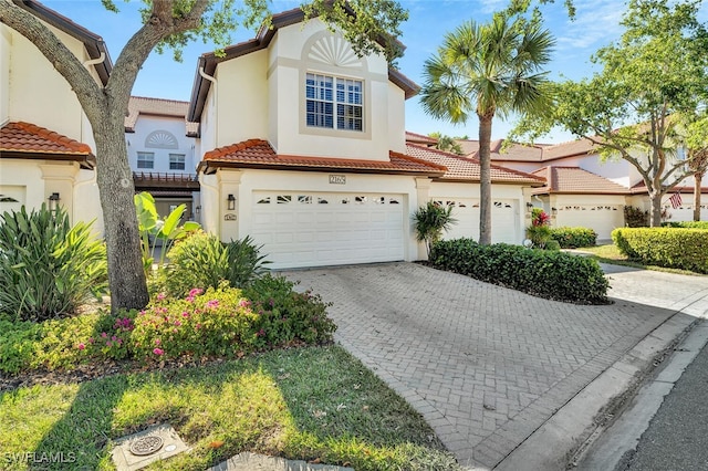 mediterranean / spanish-style home featuring a garage