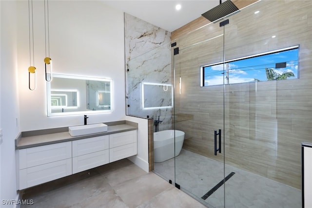 bathroom featuring separate shower and tub and vanity