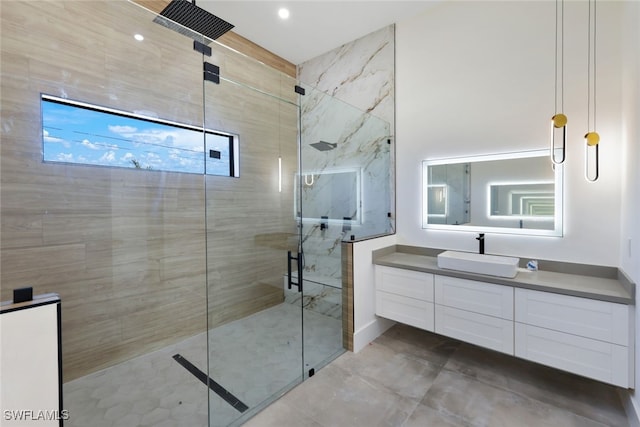 bathroom featuring vanity and tiled shower