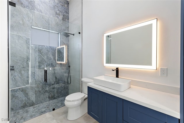 bathroom featuring vanity, an enclosed shower, and toilet