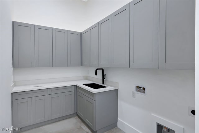 laundry area featuring cabinets, washer hookup, and sink