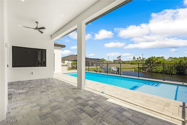 view of pool with ceiling fan, a fenced in pool, a patio, and fence