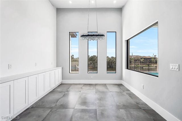 unfurnished dining area with a chandelier