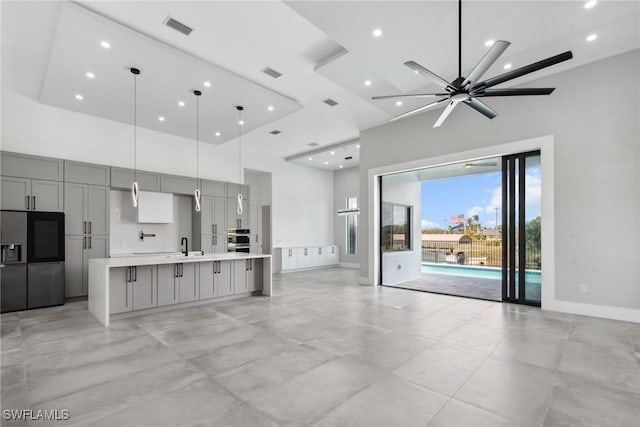 living area featuring recessed lighting, visible vents, a towering ceiling, and baseboards