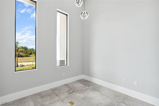 spare room with baseboards