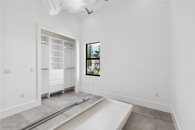 unfurnished bedroom with a closet and baseboards