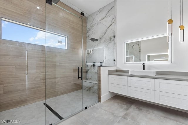 bathroom featuring a shower stall and vanity