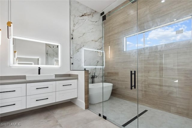 full bathroom with a stall shower, a soaking tub, and vanity