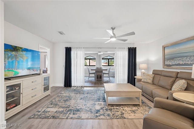 living room featuring ceiling fan and wood-type flooring