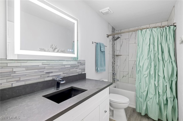 full bathroom with tasteful backsplash, vanity, shower / bath combination with curtain, and toilet