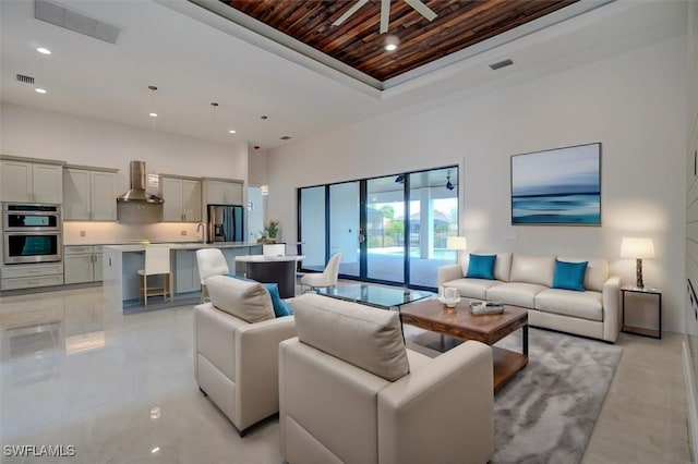 living room with wooden ceiling and a high ceiling