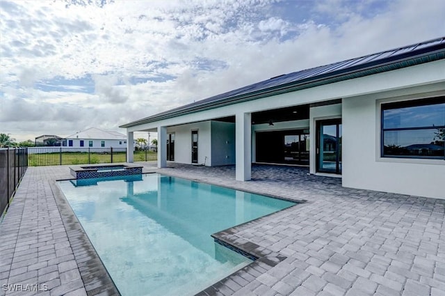 view of pool featuring an in ground hot tub and a patio