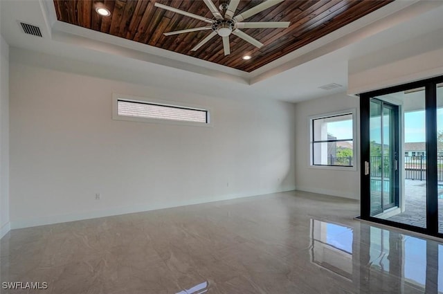 unfurnished room with a raised ceiling, ceiling fan, and wooden ceiling