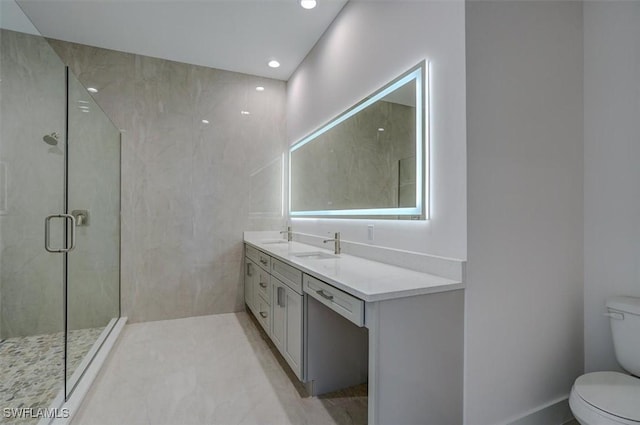 bathroom with tile patterned floors, vanity, toilet, and walk in shower