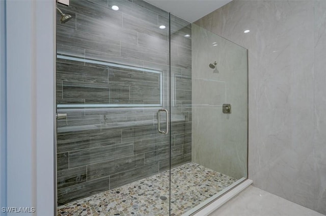 bathroom with a shower with shower door