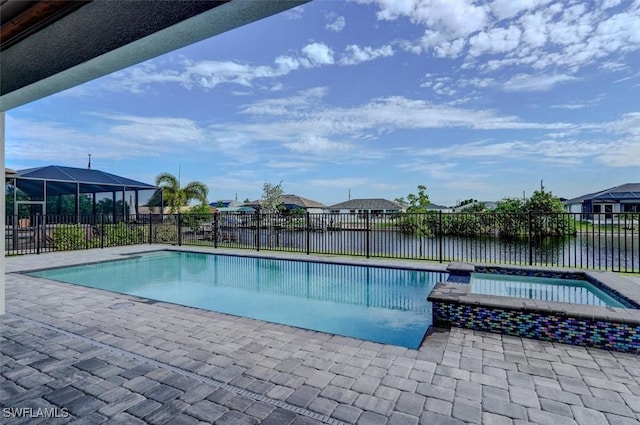 view of swimming pool with a water view and an in ground hot tub