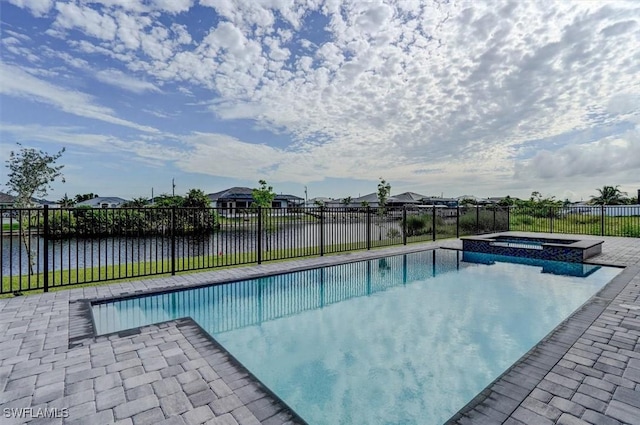 view of pool with a water view and an in ground hot tub