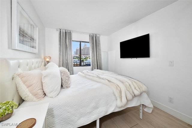 bedroom with hardwood / wood-style floors