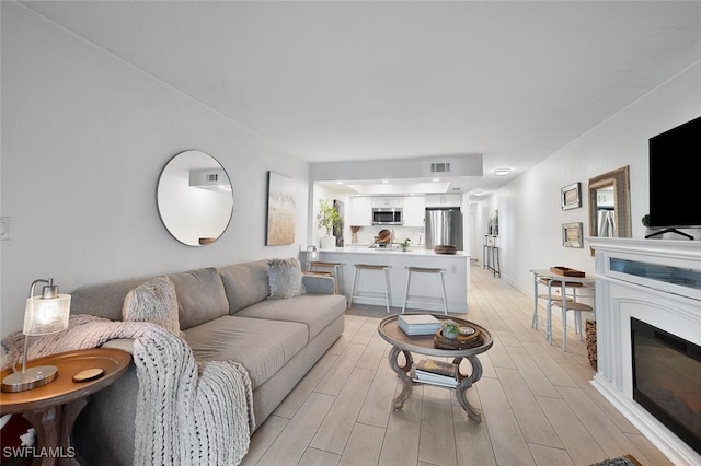 living room with light hardwood / wood-style floors