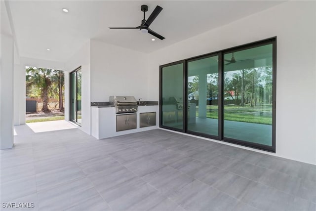 view of patio / terrace with ceiling fan, area for grilling, and a grill