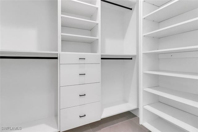 walk in closet with tile patterned floors