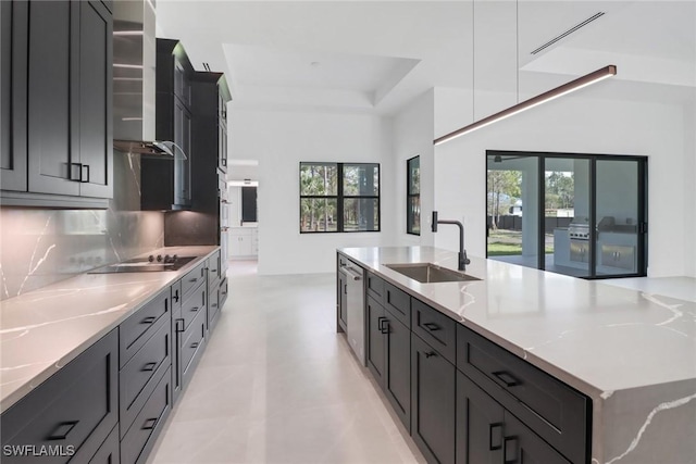 kitchen featuring sink, black electric cooktop, stainless steel dishwasher, light stone countertops, and decorative backsplash