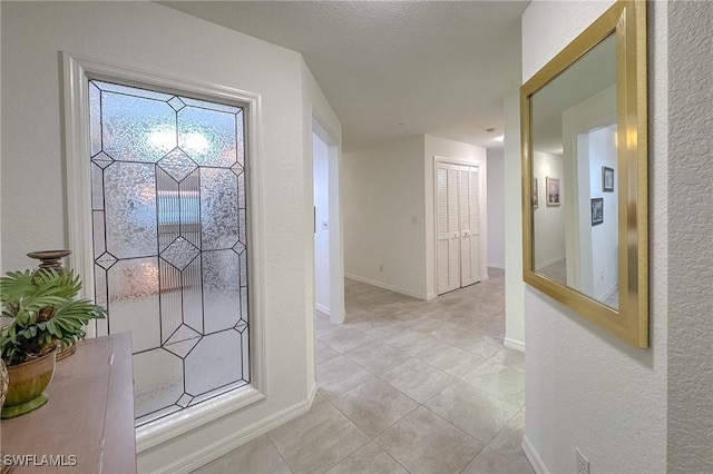 corridor with light tile patterned floors