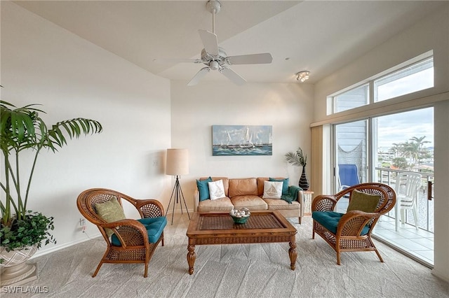 carpeted living room with ceiling fan