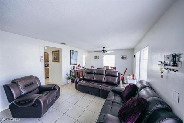 living room with ceiling fan and light tile patterned flooring