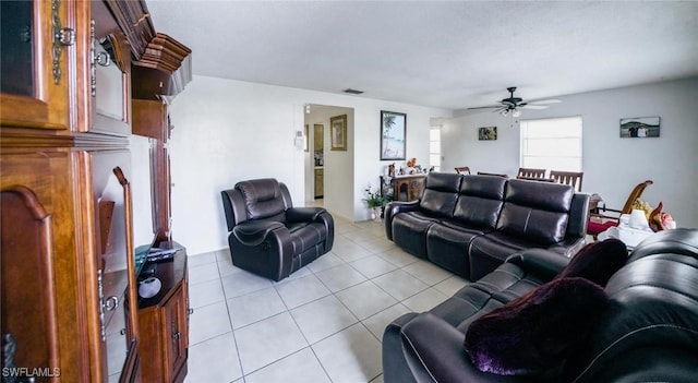 tiled living room with ceiling fan